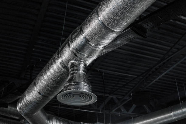 istock Ventilation system on the ceiling of large buildings. Ventilation pipes in silver insulation material hanging from the ceiling inside new building. 1012679786