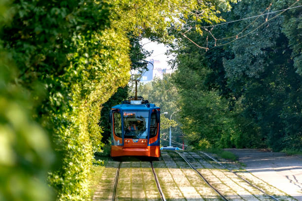 istock The tram is approaching among the green trees 1012680134