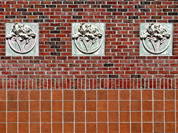 istock Concrete 3 Flowers on Red Brick Wall 1012682310
