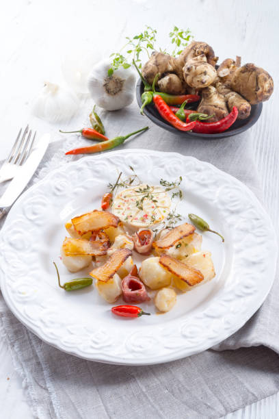 istock Jerusalem artichoke au gratin with ham and chili 1012683346