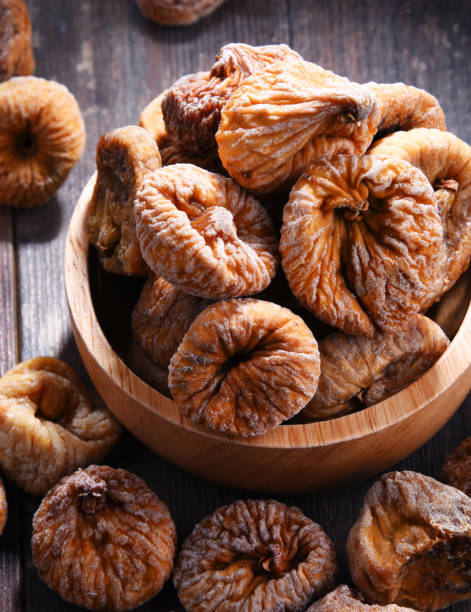 istock Composition with bowl of dried figs on wooden table 1012688180