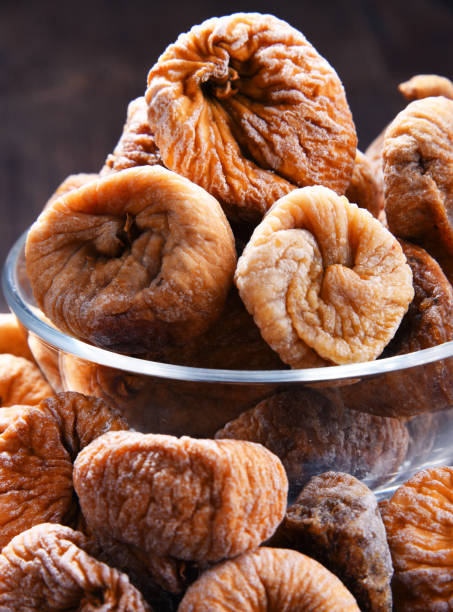istock Composition with bowl of dried figs on wooden table 1012688212