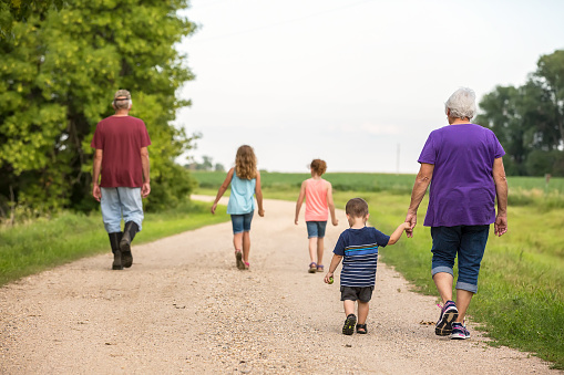 Three Kids & Grandparents Walking Down Rural Gravel Driveway