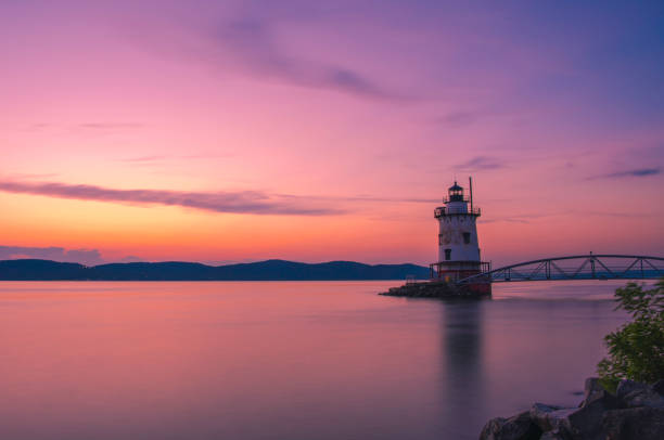 Peaceful moment Gorgeous sunset over Sleepy Hollow lighthouse viewed from Tarrytown in New York State's Hudson Valley, shot using slow shutter speed hudson valley stock pictures, royalty-free photos & images