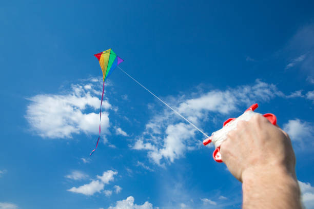 istock Kite flying in the sky among the clouds 1012699168