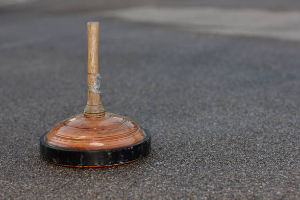 istock Wooden curling stone on common curling rink 1012701394