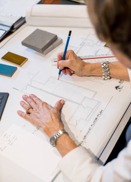 istock Senior woman in design office working on plans 1012737622