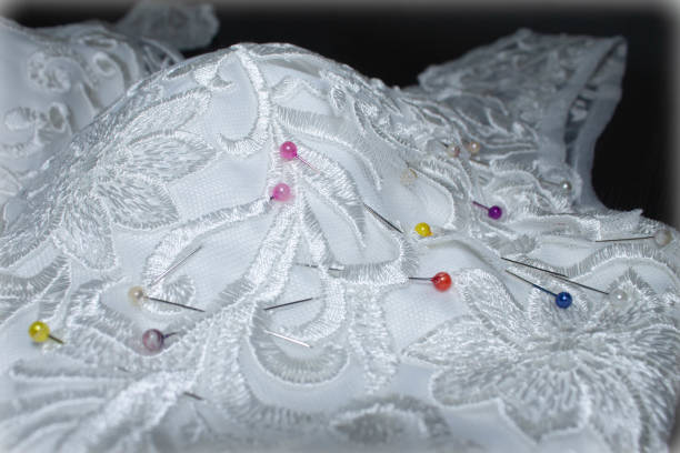istock sewing wedding dress, needle in the fabric pattern 1012745624