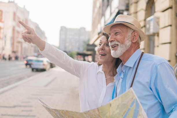 istock Elderly woman showing direction to a man with the map 1012749090