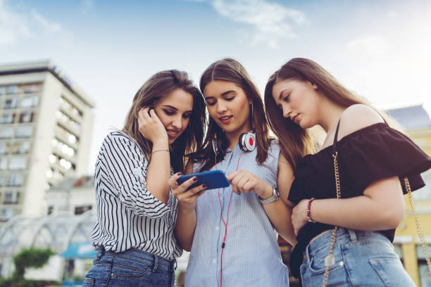 istock Three friends looking at phone content together 1012757858