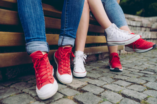 istock Female legs in sneakers 1012758028