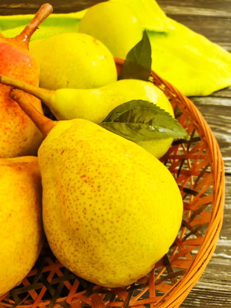 istock pear ripe on a black wooden background, fall harvest 1012760720
