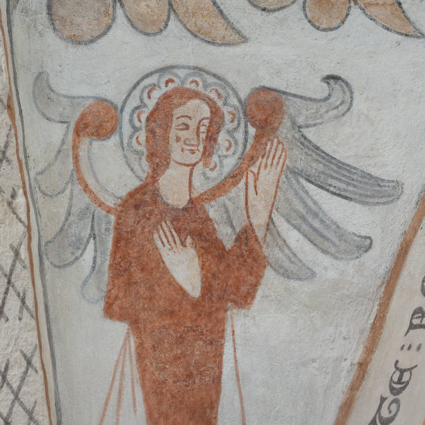 angel with two big wings lifting up his hands, a gothic fresco - denmark indoors church angel imagens e fotografias de stock