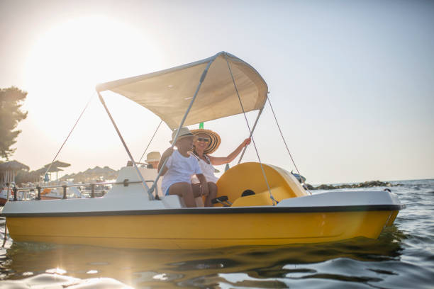 istock Mother and two sons on a pedal boat 1012763358