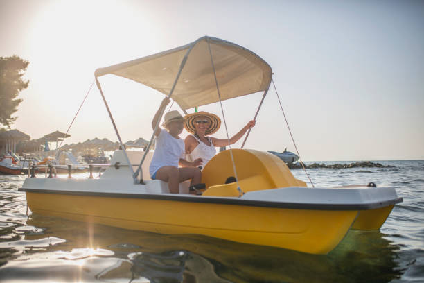 istock Mother and two sons on a pedal boat 1012763360