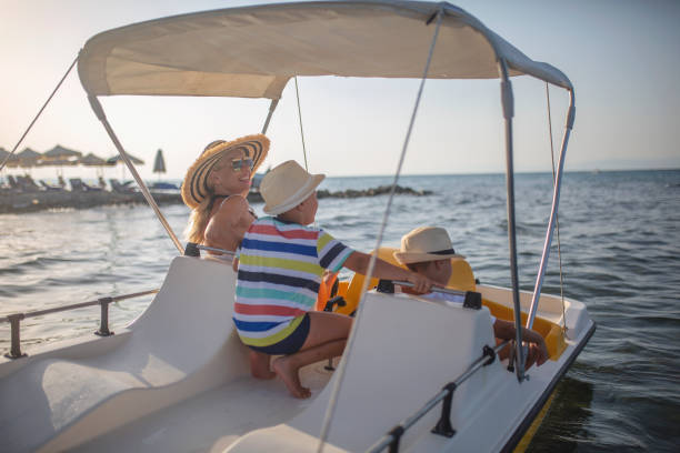 istock Mother and two sons on a pedal boat 1012763388