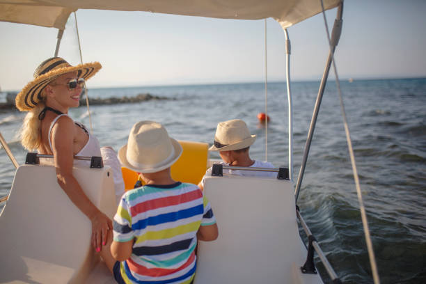 istock Mother and two sons on a pedal boat 1012765824