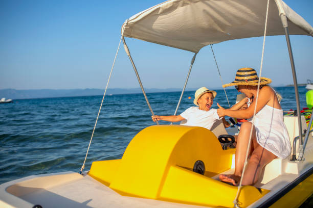 istock Mother and two sons on a pedal boat 1012771562