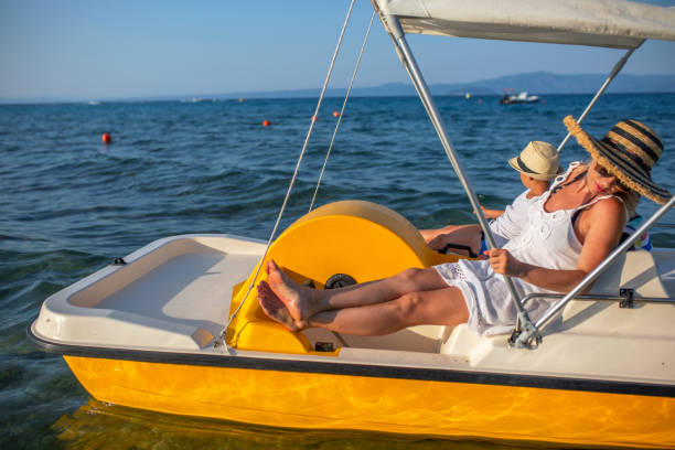 istock Mother and two sons on a pedal boat 1012779018