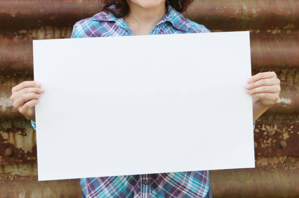 istock Unrecognizable woman holding sign 1012779182