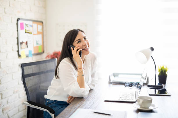 istock Businesswoman making a phone call from her desk 1012790850