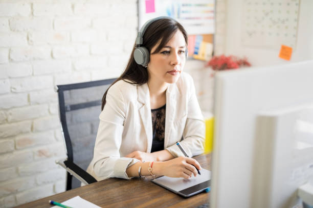 istock Designer listening music at work 1012790990