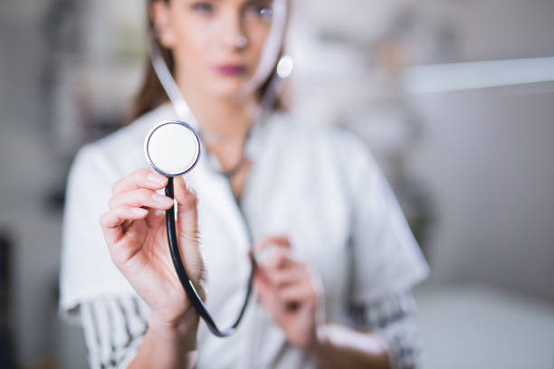 Cheerful doctor using stethoscope.