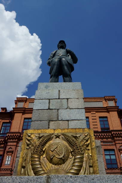 Lenin monument on background of blue sky and brick building