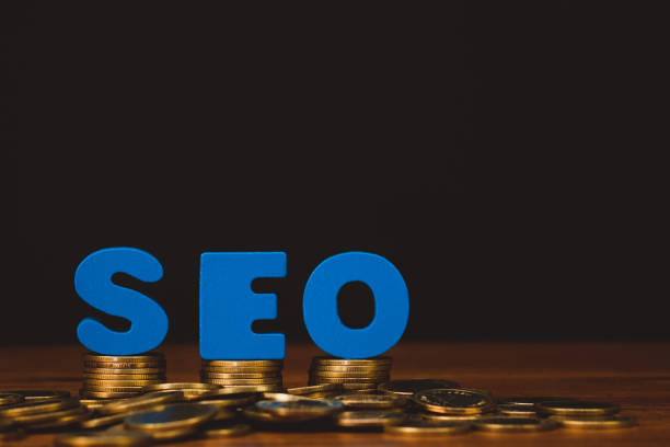 istock SEO text alphabet for Search Engine Optimization concept and coin money stack on wooden working table, business SEO idea. 1012802070