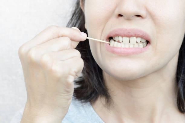 istock woman use wooden toothpick 1012806490
