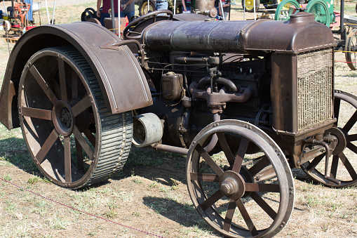 Vintage Metal Tractor With Unusual Wheels On Display