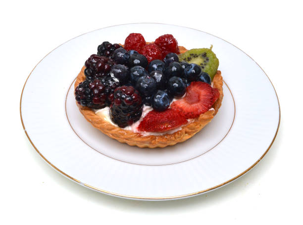 istock Fresh fruit tart in white plate on white 1012826238