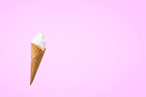 Ice cream in the cone on pink background.