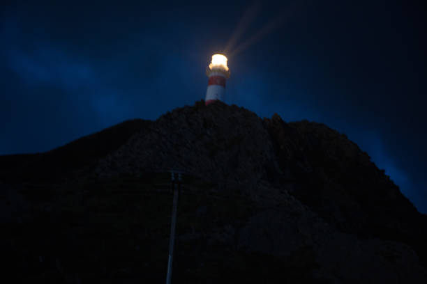 istock Lighthouse shinning on the rock at the Cape 1012848024