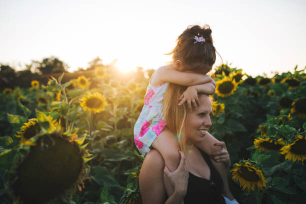 istock Mother preparing a sunflower surprise for her daughter 1012848154