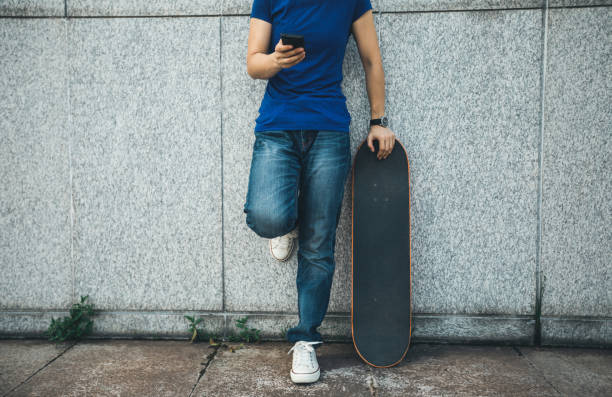 istock one skateboarder use mobile phone on city 1012850664