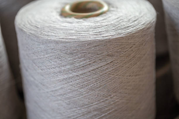 istock spindle with grey flax thread in the jean factory 1012852698