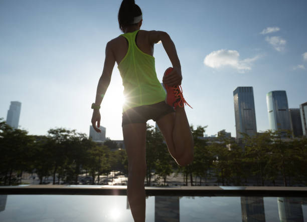 istock Healthy lifestyle woman runner warming up before running 1012855046