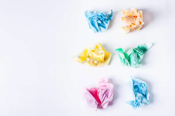 Crumpled colored paper on a white background, smooth blue sheet