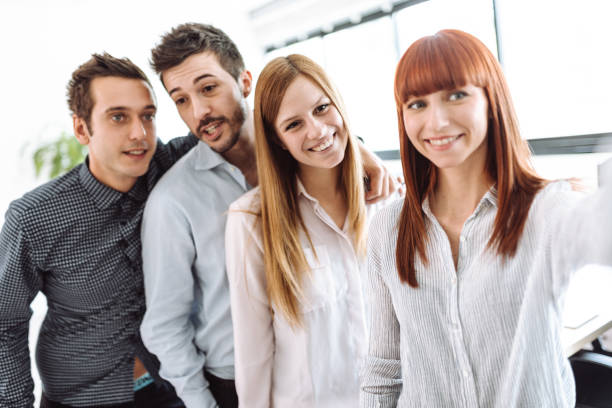 istock business team all together take a selfie 1012916176