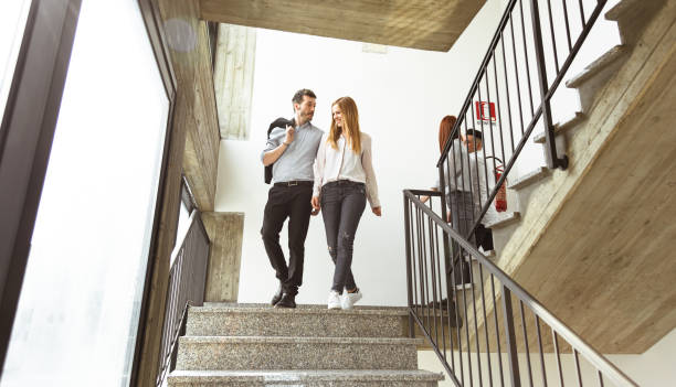 istock friends colleagues descending the staircase 1012918798