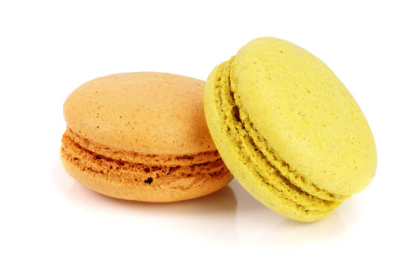 istock orange and yellow macaroon isolated on white background closeup 1012930216