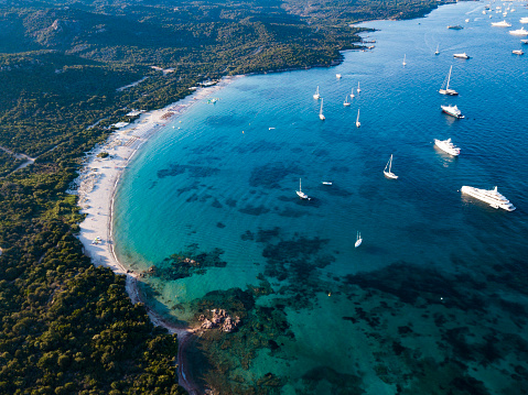 View from above, aerial view of an emerald and transparent Mediterranean sea with a white beach and some boats and yachts. Sardinia, Sardinia, Italy