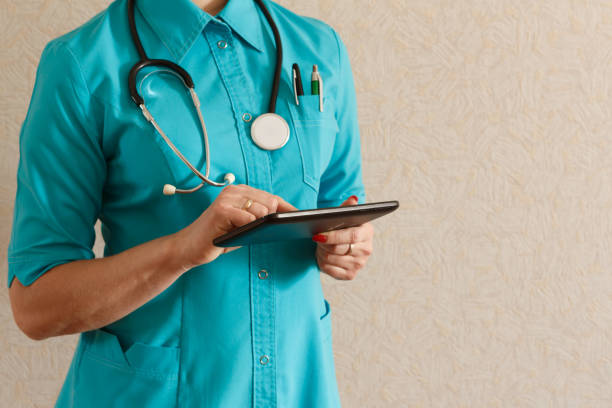 istock Doctor in gloves works on a tablet 1012948022