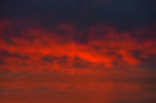 Awesome sinister burning clouds, the dark red crimson sky looks like it is on fire. Full frame image.