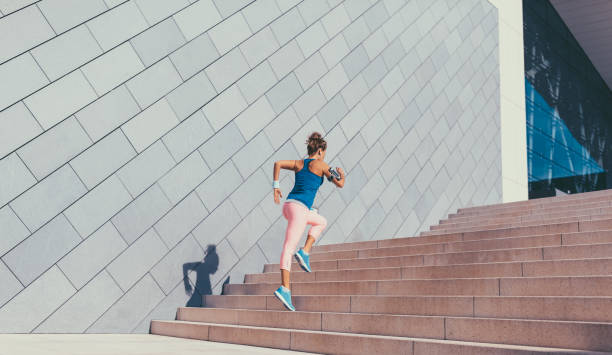 istock Sportswoman running upstairs 1012959184