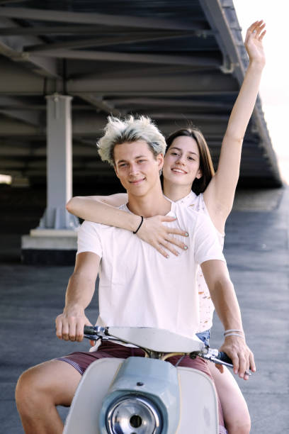 istock Young beautiful couple riding on old scooter 1012967558