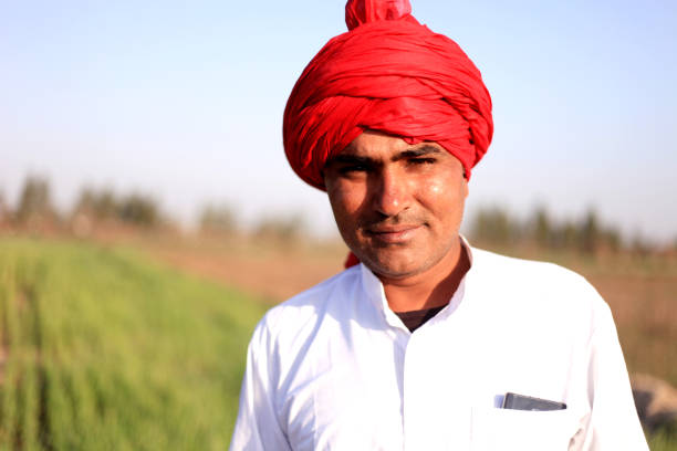 istock Farmer standing portrait in the field 1012986172