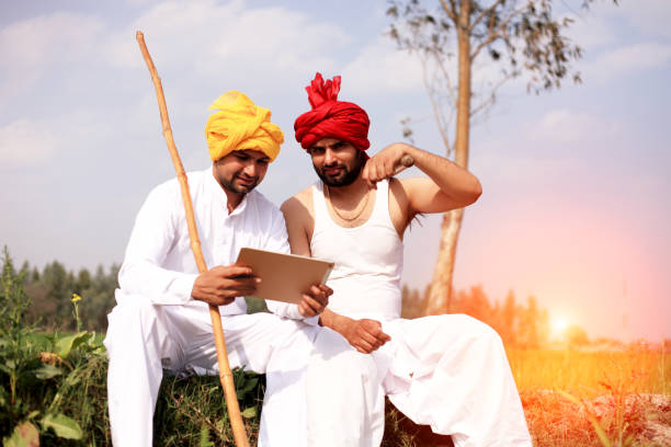istock Farmers using laptop outdoor in the field 1012988526