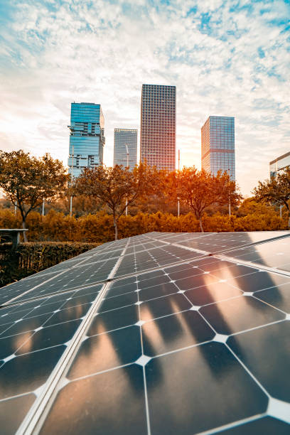 istock Ecological energy renewable solar panel plant with urban landscape landmarks 1013002116